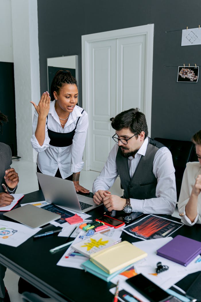 Business team in office, engaged in a serious discussion over deadlines and strategies.
